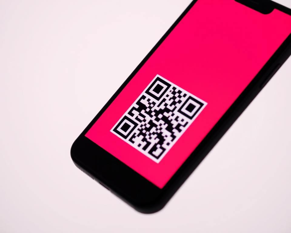 A close-up of a smartphone screen displaying a vibrant, QR code-style graphic against a blurred, minimalist background. The QR code is prominently featured, rendered in bold, geometric lines and contrasting colors that draw the eye. The screen is illuminated by a soft, directional light source, creating subtle highlights and shadows that give the image a sense of depth and dimensionality. The overall mood is one of simplicity, technology, and the seamless sharing of digital information. A close-up of a smartphone screen displaying a vibrant, QR code-style graphic against a blurred, minimalist background. The QR code is prominently featured, rendered in bold, geometric lines and contrasting colors that draw the eye. The screen is illuminated by a soft, directional light source, creating subtle highlights and shadows that give the image a sense of depth and dimensionality. The overall mood is one of simplicity, technology, and the seamless sharing of digital information.